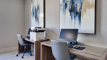 A modern office with a desk, chair, and computer.